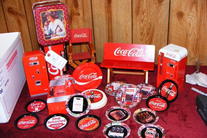 Assorted Coca Cola memorabilia - coasters, radios, bank, ashtray, miniature furniture