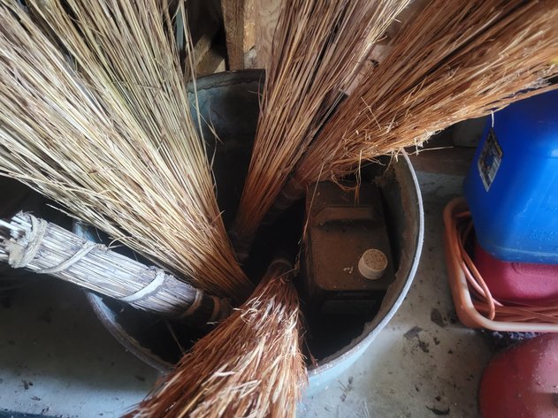 Barrel, metal fuel can, straw brooms