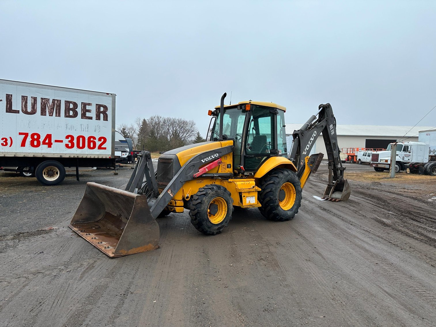 (2) Backhoes, New Holland Skid Loader, Plows