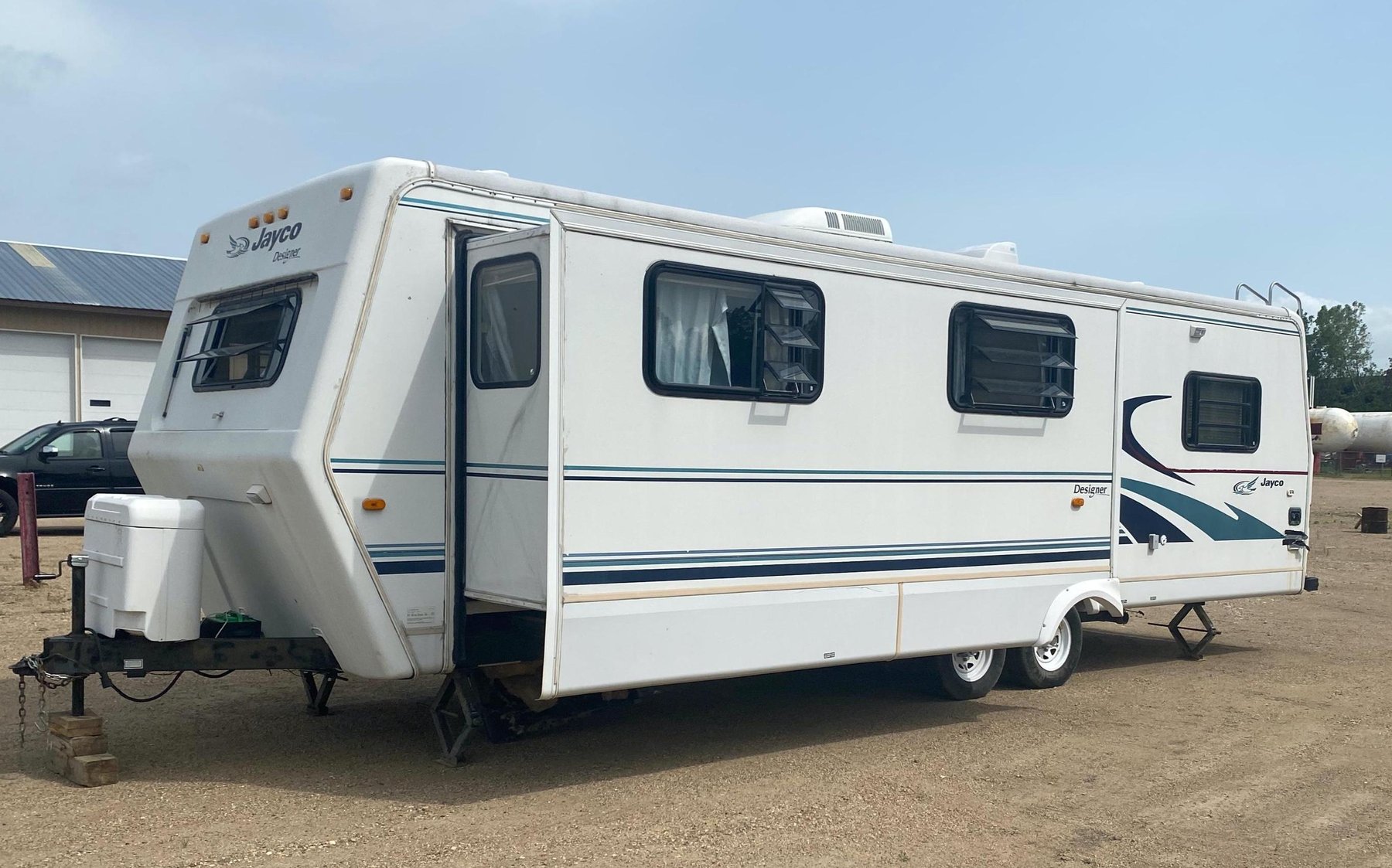 Jayco Designer Camper, Lund 14' Boat, 1991 Pontiac Sunbird Convertible & (2) Irrigator Pumps