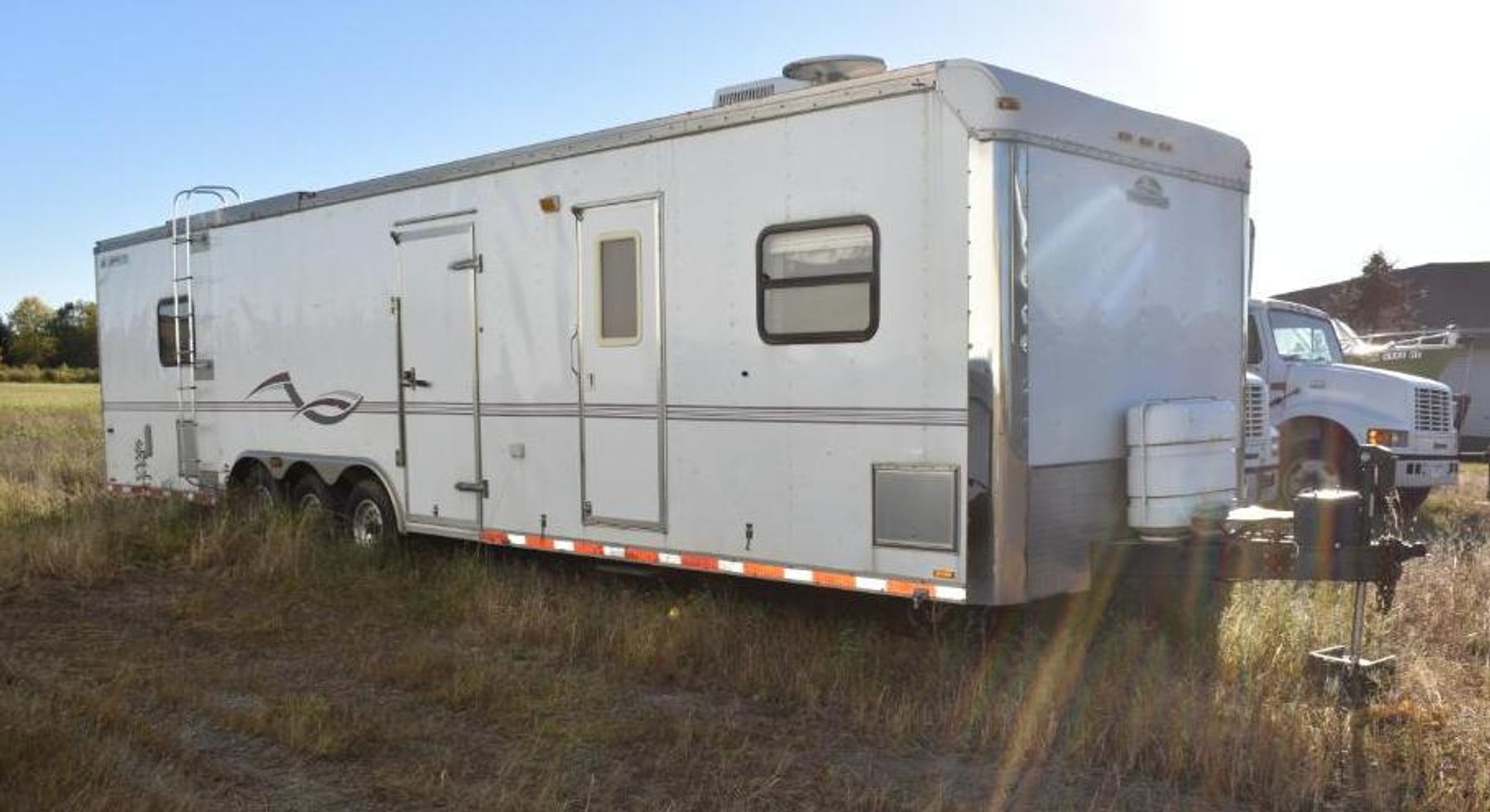 (5) Storage Trailers, 1999 International 4700 Straight Truck, 2002 CampMaster Toy Hauler