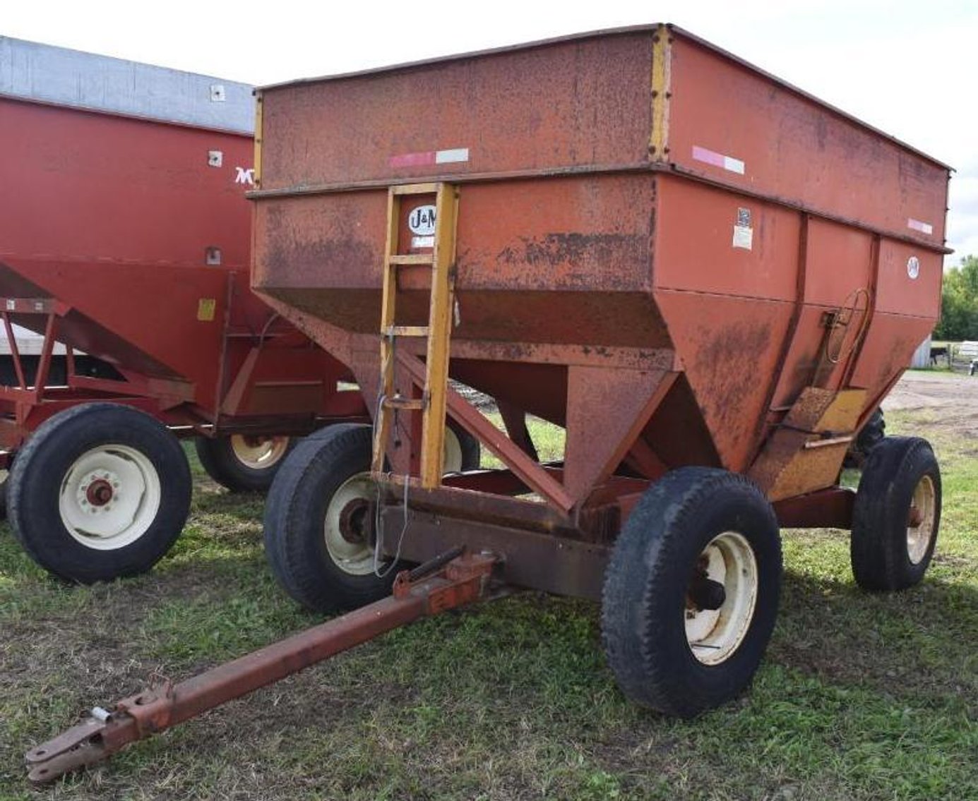 (5) Gravity Boxes, Mighty 8 Round Bale Hauler & Massey Ferguson 1100 Diesel Tractor